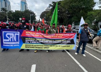 Aksi demo buruh di Jalan Medan Merdeka Selatan membuat lalu lintas menuju Patung Kuda macet panjang. Massa buruh menuntut kenaikan Upah Minimum Provinsi Jakarta. (Foto: Andreas Kristianto/Bloomberg Technoz)