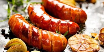 Resep sosis bakar bumbu BBQ smokey manis gurih yang praktis, hemat, dan mudah dibuat. Cocok untuk camilan sore, bakaran, atau ide jualan. (Foto: Detik Food)