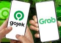 Masuknya Danantara ke saham aplikator ojol dinilai jadi sinyal kuat merger Gojek dan Grab. Analis soroti dampak ke pasar dan pengemudi. (Foto: Bloomberg Technoz)